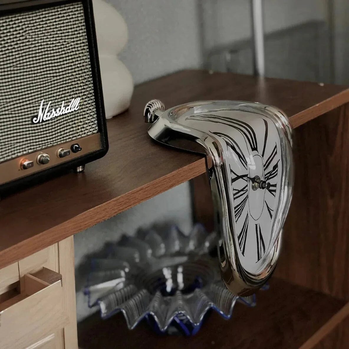 A beautiful Dali clock near an old radio